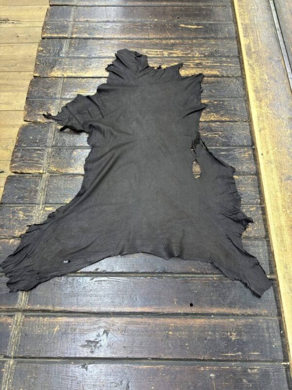 Black leather hide on wooden surface.