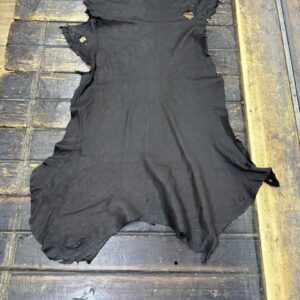 IMG_1978 Black leather hide on wooden surface.