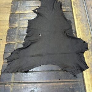 IMG_1981 Black leather hide on wooden surface.