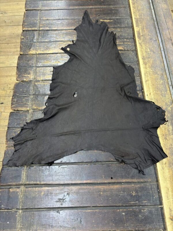 Black leather hide on wooden surface.