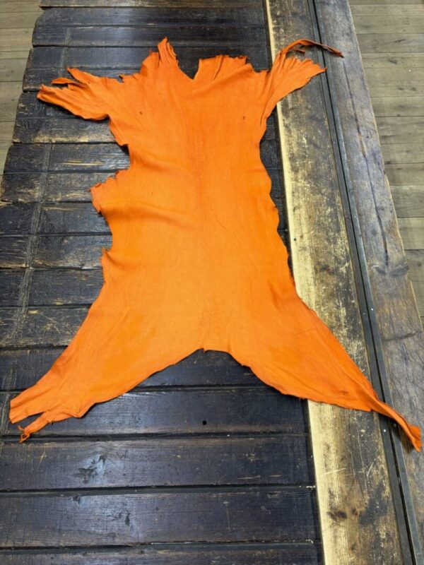 IMG_2016 Orange leather hide on a wooden surface.