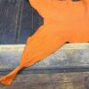 IMG_2017 Orange leather hide on wooden table.