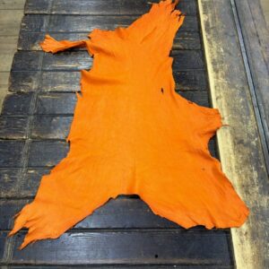 IMG_2032 Orange animal hide on wooden table.