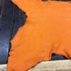 IMG_2033 Orange leather hide on wooden surface.