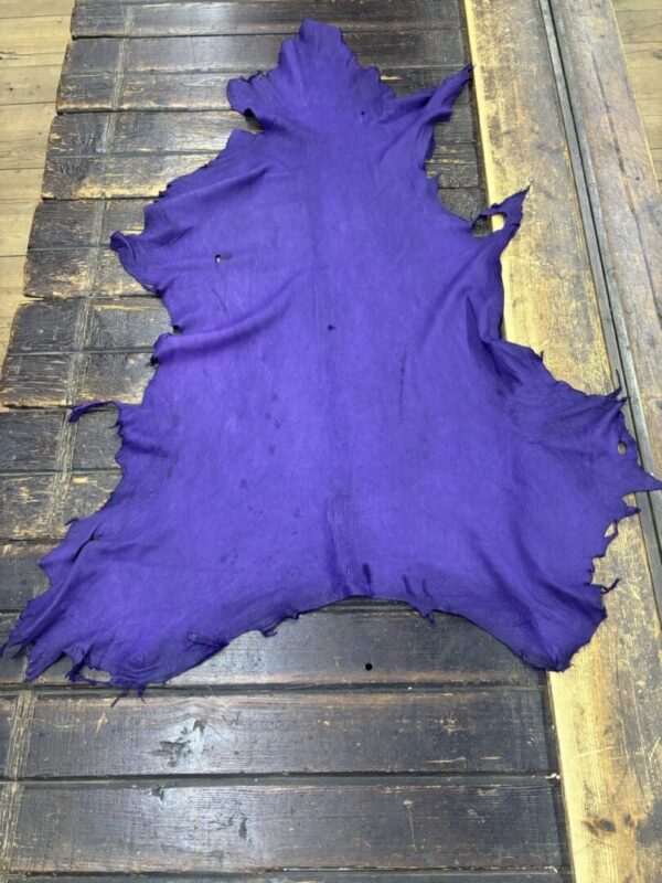 Purple leather piece on wooden surface.
