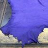 Purple leather hide on a wooden surface.