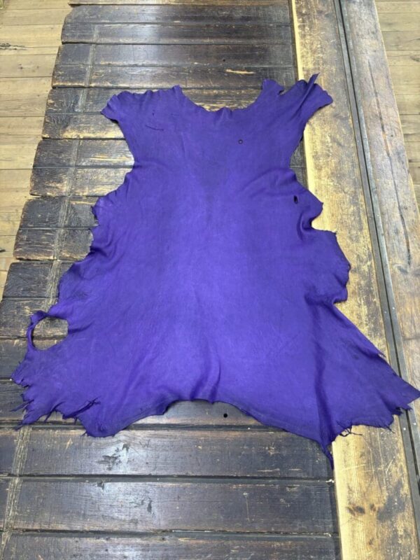Purple leather hide on wooden surface.