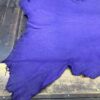 Purple leather piece on wooden surface.
