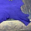 Purple leather piece on wooden surface.