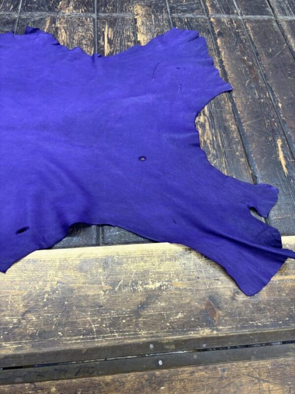 Purple leather piece on wooden surface.