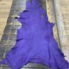 Purple leather hide on wooden surface.