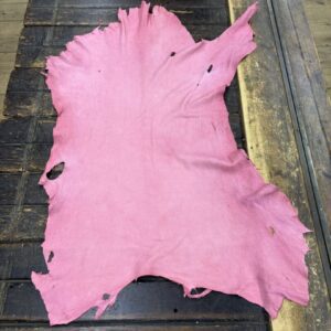 IMG_2055 Pink leather laid out on a wooden table.