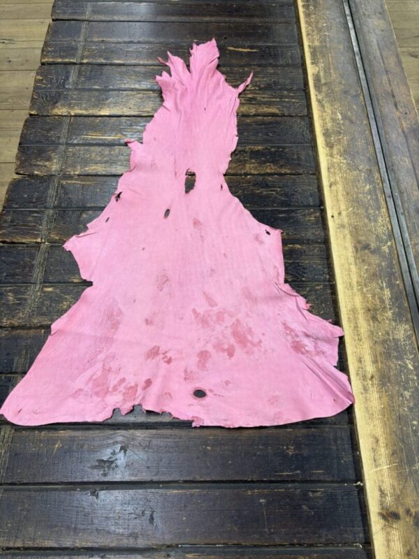 IMG_2059 Pink leather piece on a wooden table.