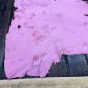 IMG_2060 Pink leather hide on wooden surface.