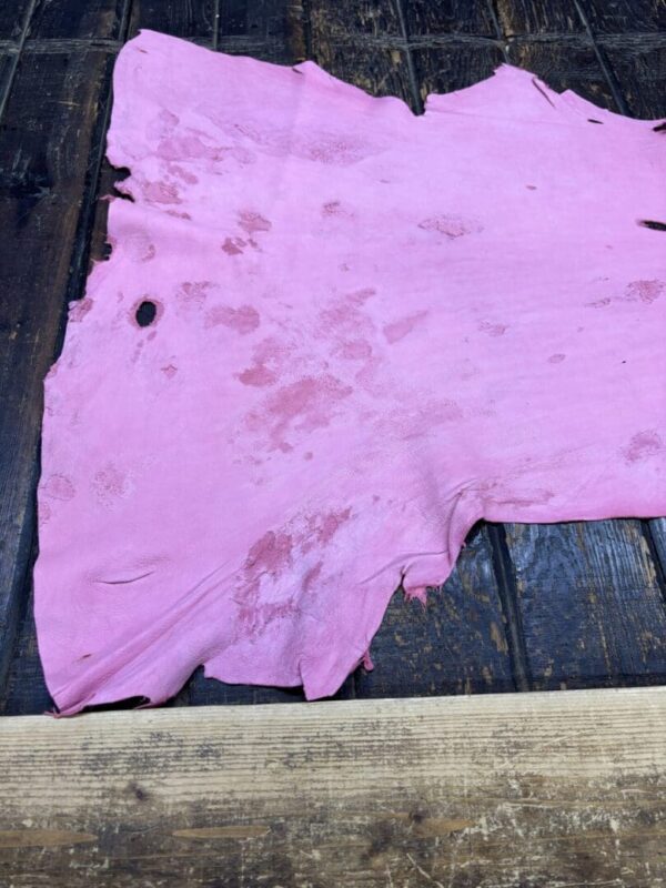 IMG_2060 Pink leather hide on wooden surface.