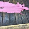 IMG_2062 Pink leather piece on wooden surface.