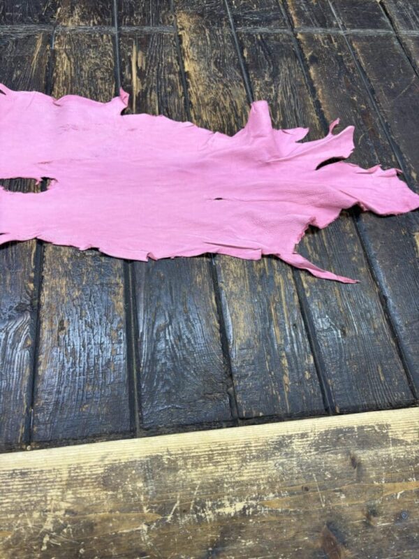 IMG_2062 Pink leather piece on wooden surface.