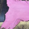IMG_2066 Pink leather piece on wooden surface.