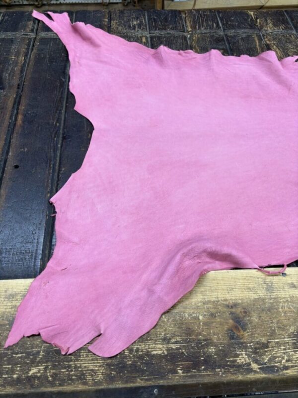 IMG_2066 Pink leather piece on wooden surface.