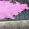 IMG_2067 Pink leather piece on wooden surface.