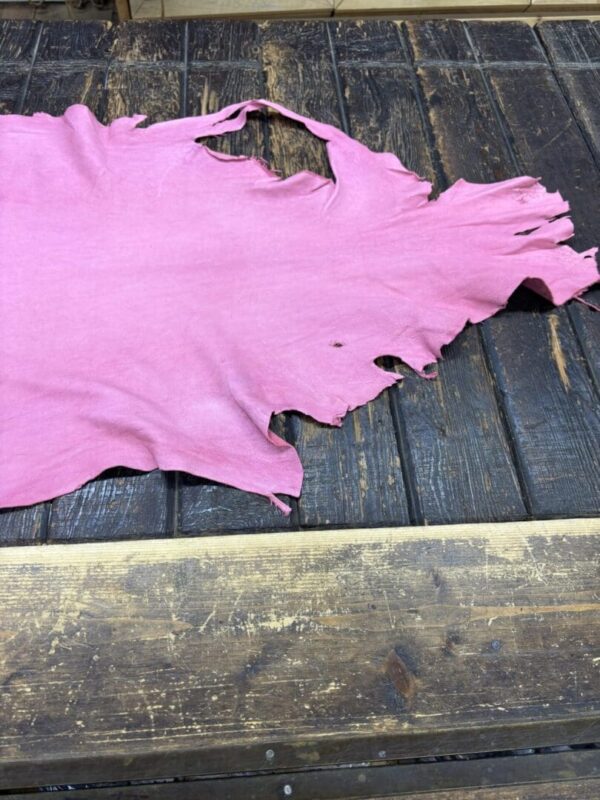 IMG_2067 Pink leather piece on wooden surface.