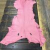 IMG_2069 Pink leather hide on a wooden surface.