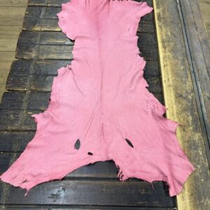 IMG_2069 Pink leather hide on a wooden surface.