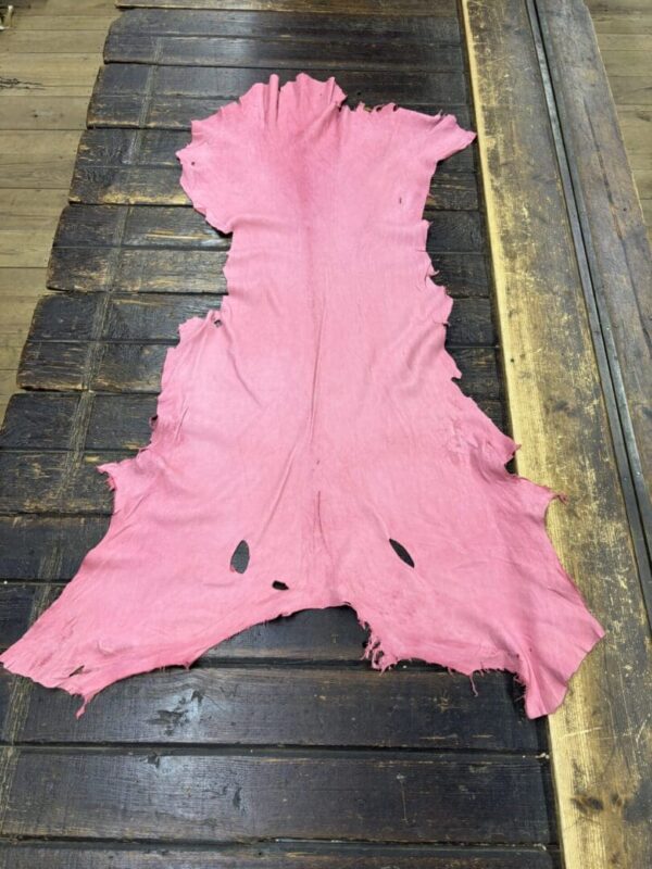 IMG_2069 Pink leather hide on a wooden surface.