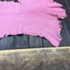 IMG_2071 Pink leather piece on wooden surface.