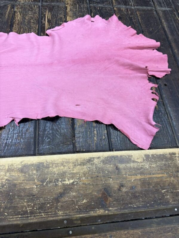 IMG_2071 Pink leather piece on wooden surface.