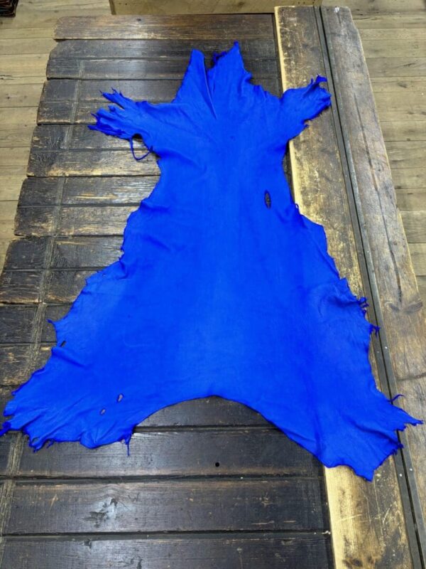 IMG_2080 Bright blue leather on a wooden surface.