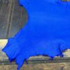 IMG_2081 Bright blue leather piece on wooden surface.