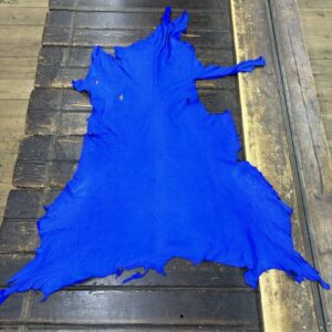IMG_2084 Bright blue leather hide on wooden surface.