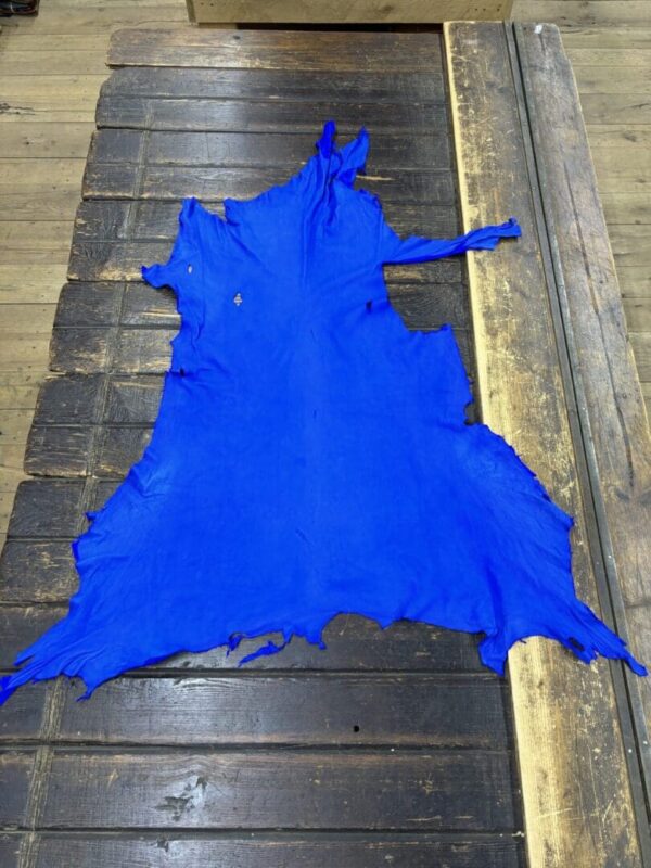 Bright blue leather hide on wooden surface.