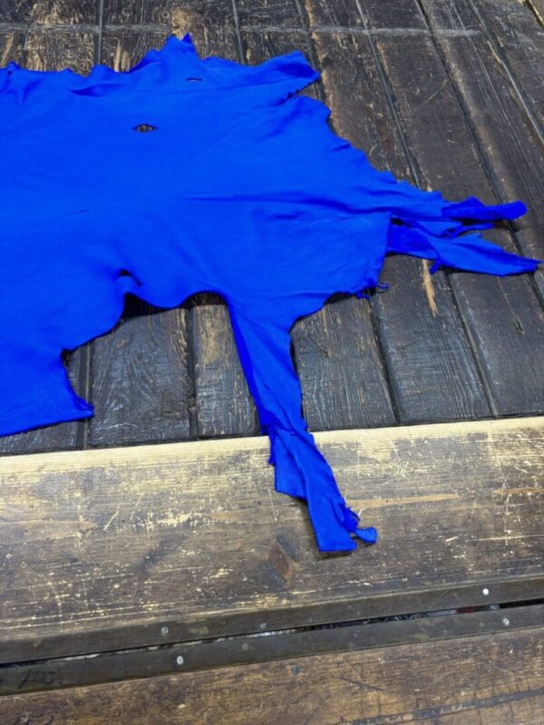 Blue textile piece on wooden surface.