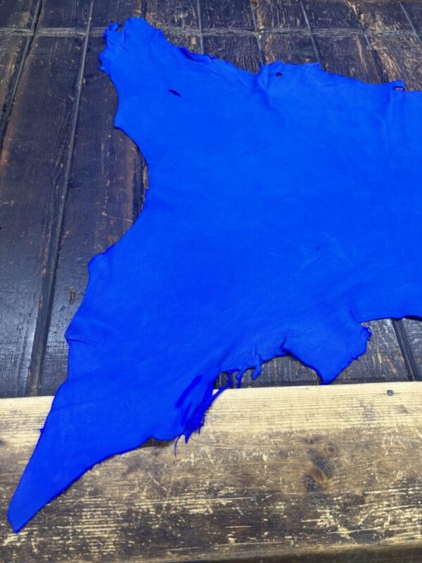 IMG_2093 Blue leather piece on a wooden surface.