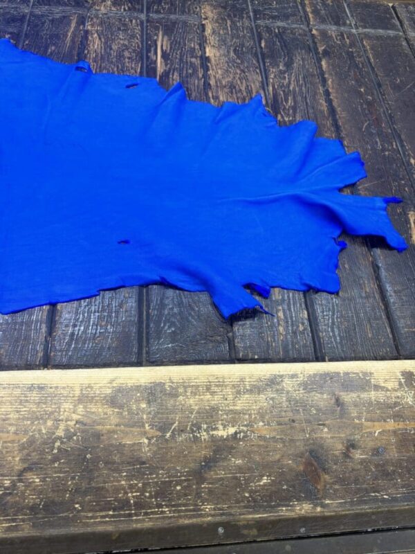 IMG_2094 Bright blue fabric draped on wooden surface.