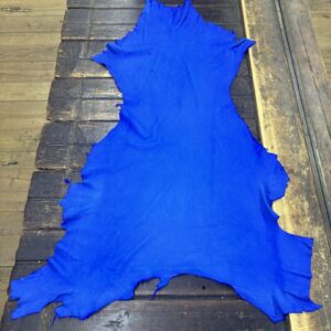 IMG_2096 Bright blue leather hide on wooden surface.