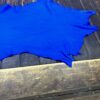 Blue leather piece on wooden surface.