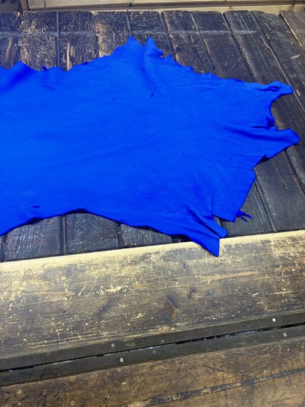 Blue leather piece on wooden surface.