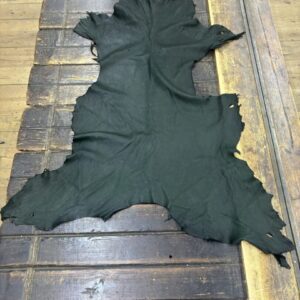 IMG_2100 Black leather hide on a wooden surface.