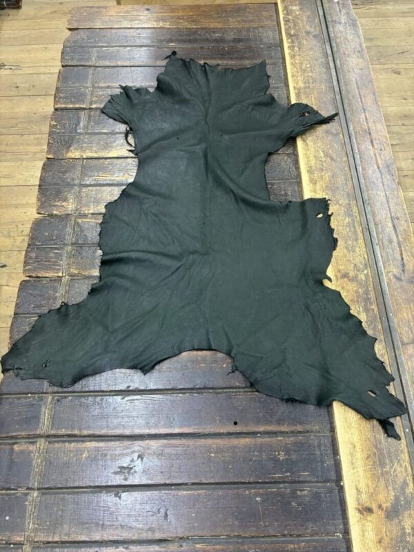 Black leather hide on a wooden surface.