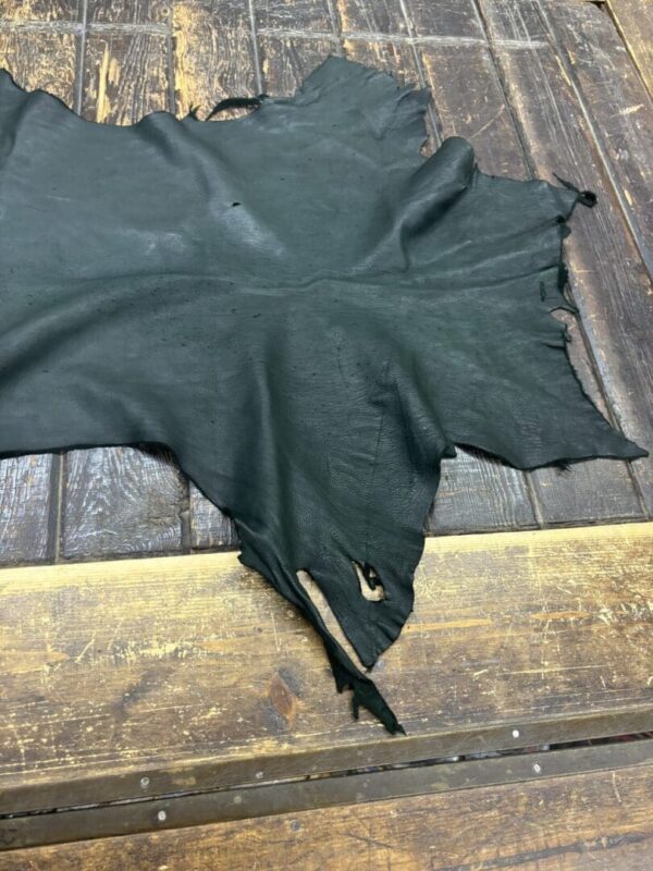 Black leather hide on wooden surface.