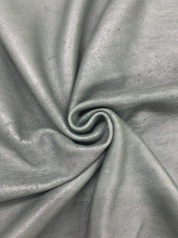 Green textured fabric in a spiral arrangement.