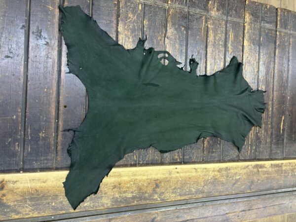 Green leather hide on a wooden surface.