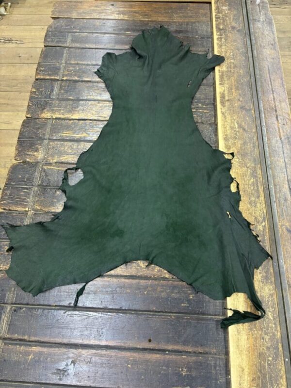 Green leather hide on wooden surface.