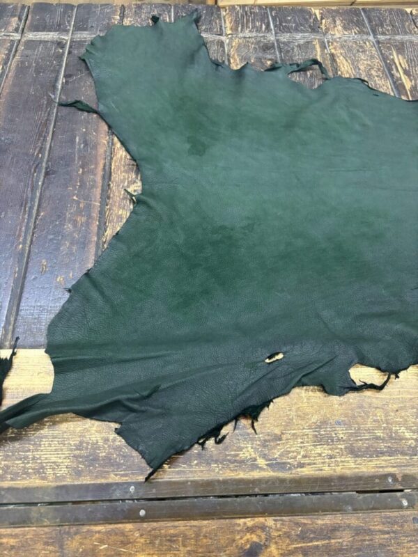 Green leather hide on wooden surface.
