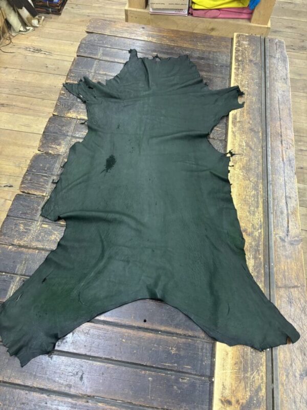 IMG_2118 - Copy Black leather hide on wooden surface.