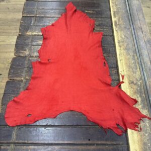 IMG_2130 Red leather hide on a wooden surface.