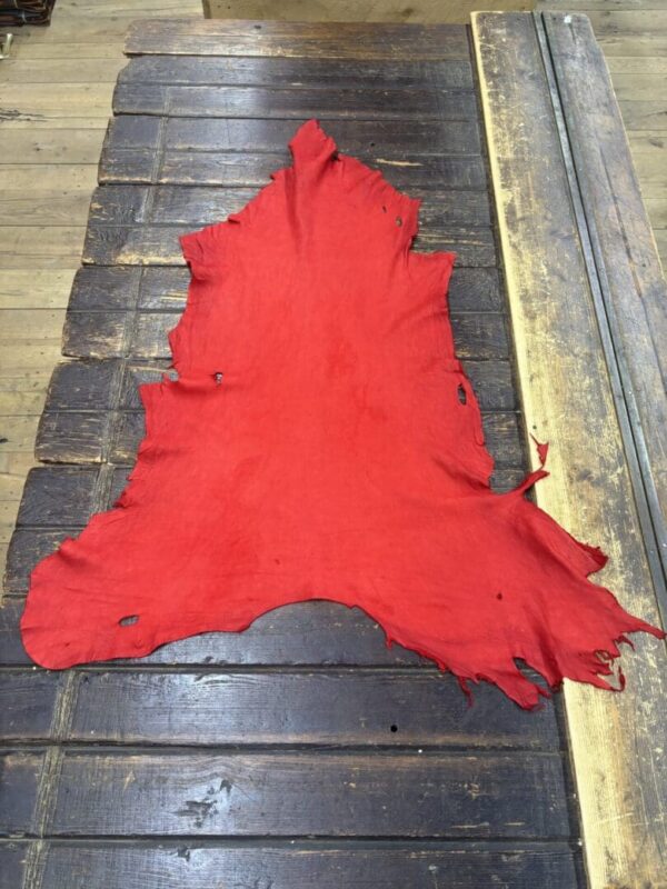 Red leather hide on a wooden surface.